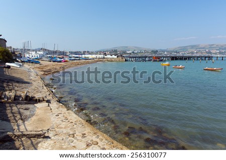 Swanage harbour and jetty Dorset England UK with sea shore blue sea and sky on a beautiful summer day on the English Jurassic coast