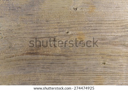 Wooden background texture uneven with lines notches and ridges brown in colour