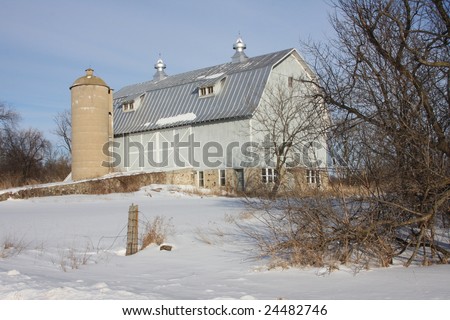 Blue wisconsin dairy barn under blue skies in winter