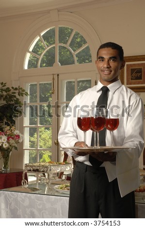 a waiter greets guests with wine
