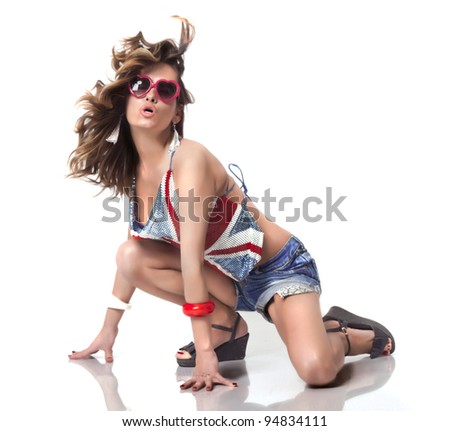 Pretty girl dancing on the floor,isolated on white. She is wearing Great Britain flag blouse/ Dance floor