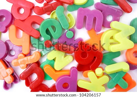 Bunch of colorful magnetic letters on a light background