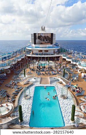 CARIBBEAN SEA - JANUARY 30, 2015: Passengers enjoy a day at sea on the top deck of the Royal Princess cruise ship during a cruise in the Caribbean Islands.