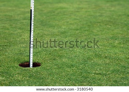 golf hole with white post, playing field