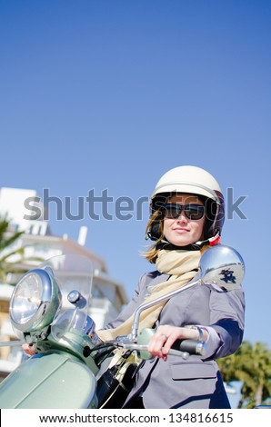 Attractive woman on a retro scooter