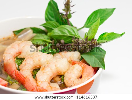 Tom Yum Goong or spicy tom yum soup with shrimp. Thai popular food menu, contained in bowl.