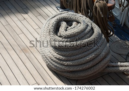 Coiled rope on wooden deck