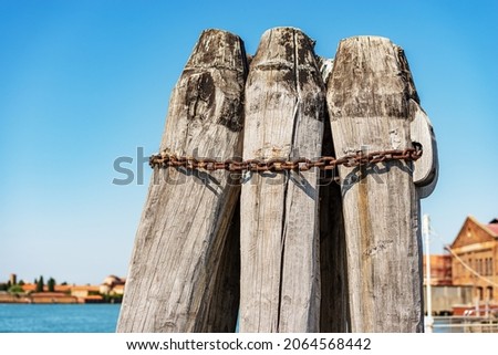 Venice Lagoon, close-up of a group of large wooden poles implanted in the seabed called Briccola or Bricola (Dolphin), used to indicate the viable routes in the sea to boats. Veneto, Italy, Europe. ストックフォト © 