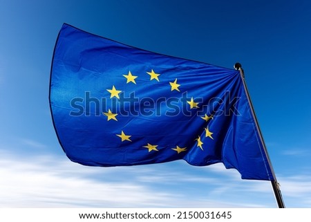 Close-up of an European Union flag waving against a clear blue sky with clouds and copy space. 商業照片 © 