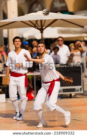 VERONA, ITALY - SEPTEMBER 21, 2014: Tocati, International festival of street games. Two athletes of Treia (Marche, Italy) does a demonstration of the game: ball with the bracelet - XVI century