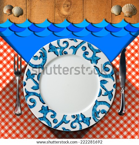 Table Arrangement for Seafood Menu / Empty plate with fork and knife, red and white checkered tablecloth, seashells and blue waves on wooden background. Table set for a seafood menu
