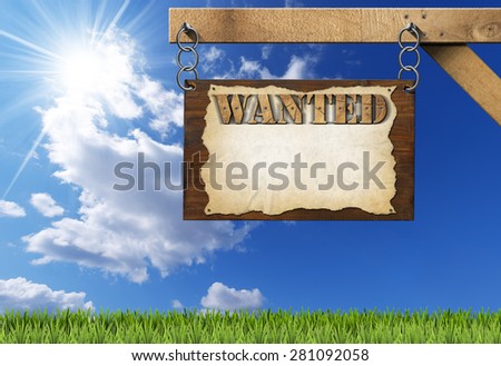Wanted - Wooden Sign with Chain. Dark wooden sign with torn empty parchment with text Wanted. Hanging from a metal chain on a wooden pole on blue sky with clouds and sun rays
