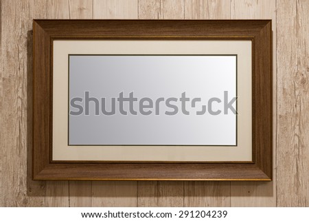 Old wooden picture frame on wooden wall background