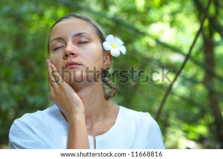 portrait of fresh and beautiful human with flower in summer environment