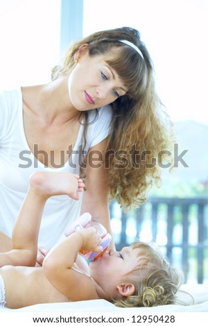 portrait of happy  young  mother with her baby. Focused on baby’s face