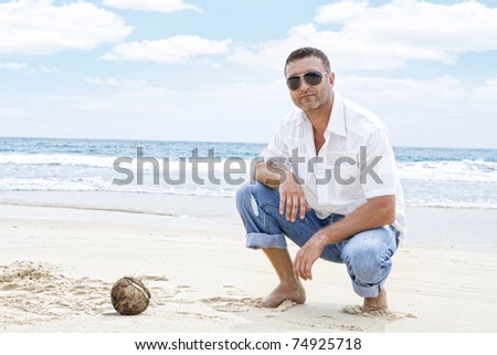 Portrait of nice young  man  having good time on tropical beach