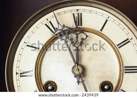 fragment of old antique clock on dark background