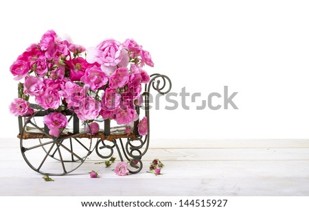 Cart full of fresh cut pink roses