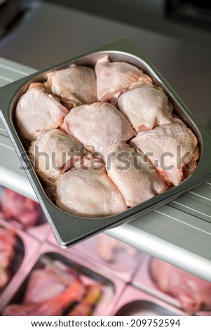 Chicken raw meat with the skin in a deep iron tray