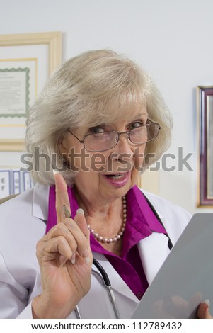 A woman doctor sitting at her desk appears to be giving a warning on a medical subject.