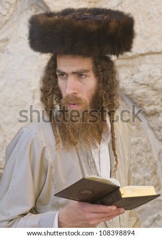 JERUSALEM - APRIL 08 : Orthodox jewish men prays in The western wall during Passover on April 08 2012 , The Western wall is important Jewish religious site located in the Old City of Jerusalem