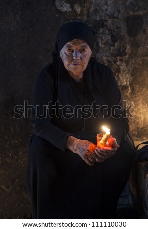 JERUSALEM - AUGUST 25 : Unidentified nun prays in the Tomb of Mary in Gethsemane during the feast of the Assumption of the Virgin Mary on August 25, 2012 in old Jerusalem, Israel