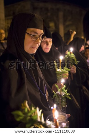 JERUSALEM - AUGUST 25: Unidentified nuns take part in a candle procession as part of the feast of the Assumption of the Virgin Mary on August 25, 2012 in old Jerusalem, Israel