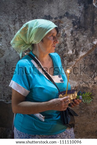 JERUSALEM - AUGUST 25: Unidentified pilgrim prays in the Tomb of Mary in Gethsemane during the feast of the Assumption of the Virgin Mary on August 25, 2012 in old Jerusalem, Israel