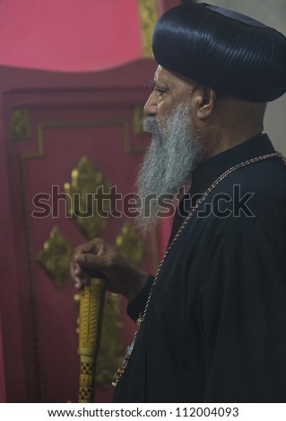 JERUSALEM - AUGUST 08 : Ethiopian priest prays at the Ethiopian Church in Jerusalem , Israel on August 08 2012 , Ethiopian church is The only pre-colonial Christian church of Sub-Saharan Africa