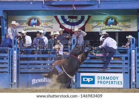 RENO , USA - JUNE 27 : Cowboy Participant in a Bull riding Competition at the Reno Rodeo  a Professional Rodeo held in Reno Nevada , USA on June 27 2013