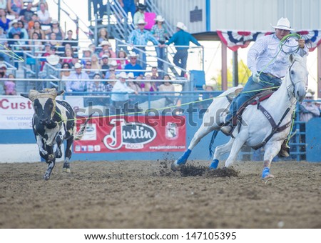 RENO , USA - JUNE 30 : Cowboy Participant in a Calf roping Competition at the Reno Rodeo  Professional Rodeo held in Reno Nevada , USA on June 30 2013