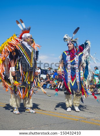 GALLUP , NEW MEXICO - AUGUST 10 : Native Americans with traditional costume participates at the 92 annual Inter-tribal ceremonial parade on August 10 , 2013 in Gallup New-Mexico