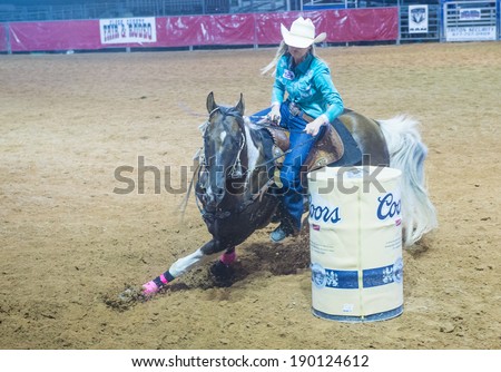 LOGANDALE , NEVADA - APRIL 10 : Cowgirl Participating in a Barrel racing competition in the Clark County Fair and Rodeo a Professional Rodeo held in Logandale Nevada , USA on April 10 2014