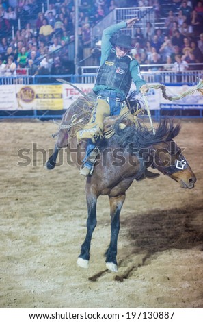 LAS VEGAS - MAY 16 : Cowboy Participating in a Bucking Horse Competition at the Helldorado days Rodeo , A Professional Rodeo held in Las Vegas on May 16 2014