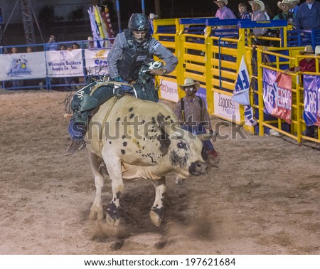 LAS VEGAS - MAY 16 : Cowboy Participating in a Bull riding Competition at the Helldorado days Rodeo , A professional Rodeo held in Las Vegas , Nevada on May 16 , 2014