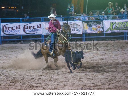 LAS VEGAS - MAY 16 : Cowboy Participating in a Calf roping Competition at the Helldorado days Rodeo , A Professional Rodeo held in Las Vegas, Nevada on May 16 2014