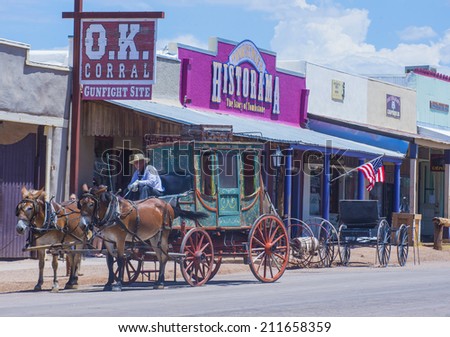 TOMBSTONE , ARIZONA - AUG 09 : A Horse drawn carriage ride in the main street of Tombstone , Arizona on August 09 2014. Tombstone is a historic western city founded in 1879