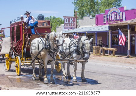 TOMBSTONE , ARIZONA - AUG 09 : A Horse drawn carriage ride in the main street of Tombstone , Arizona on August 09 2014. Tombstone is a historic western city founded in 1879