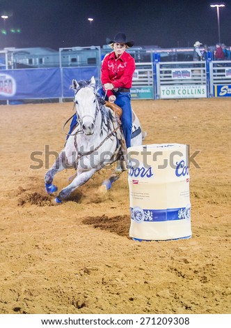 LOGANDALE , NEVADA - APRIL 10 : Cowgirl Participating in a Barrel racing competition in the Clark County Fair and Rodeo a Professional Rodeo held in Logandale Nevada , USA on April 10 2015