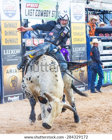 LAS VEGAS - MAY 23 : Cowboy Participating in a Bull riding Competition at the Las Cowboy Standing , a PBR cometition with the fifty of the top bull riders in the world held in Las Vegas on May 23 2015