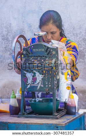 CHICHICASTENANGO , GUATEMALA - JULY 26 : Guatemalan woman Sells flavored ice at the Chichicastenango Market on July 26 2015. This native market is the most colorful in Central America