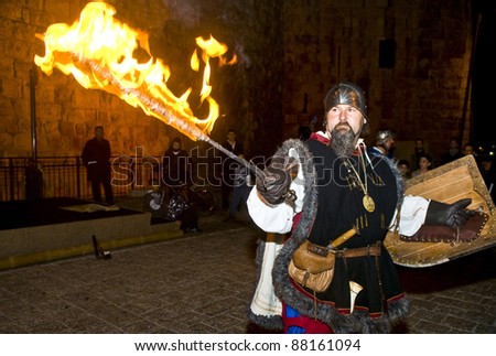 JERUSALEM - NOV 03 : An unidentified Italian actor dresses as a knight to fight with sword and fire in the annual medieval style knight festival held in the old city of Jerusalem on November 03, 2011
