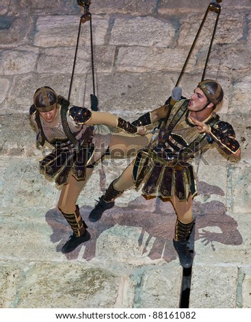 JERUSALEM - NOV 03 : An unidentified Israeli acrobats team dressed as knights climb on the old city walls in the annual medieval style knight festival held in the old city of Jerusalem on November 03, 2011