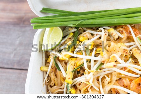 Stir fried rice noodle name Pad Thai in paper food box, Thai style food