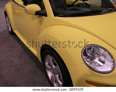 Yellow automobile bug side view, headlamp & fender & mirror