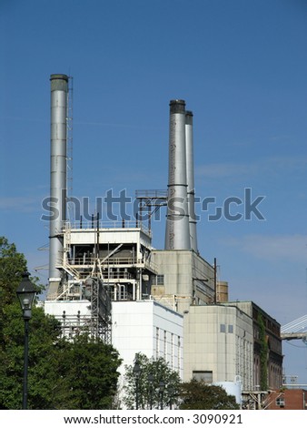 Power Station with three exhaust stacks against blue sky
