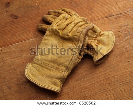 Two Work gloves crossed on wood