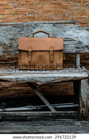 Brown Leather laptop bag corporate  on old woden chair