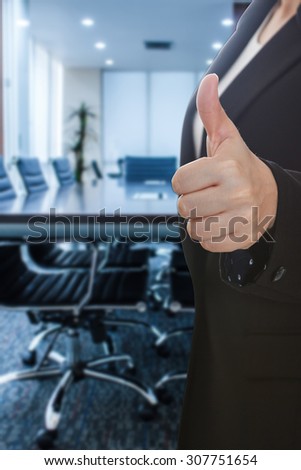 business woman thumb up show with meeting room focus Blur background