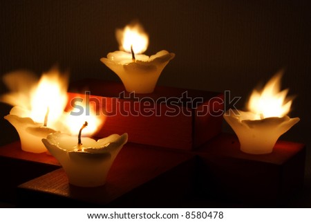 four candles blowing up by the wind